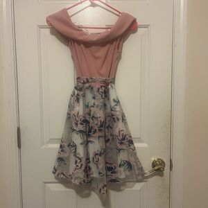 Pink floral dress with a zipper and bow in the back.